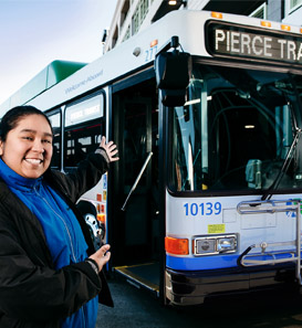 Enjoy the ride operator in front of bus